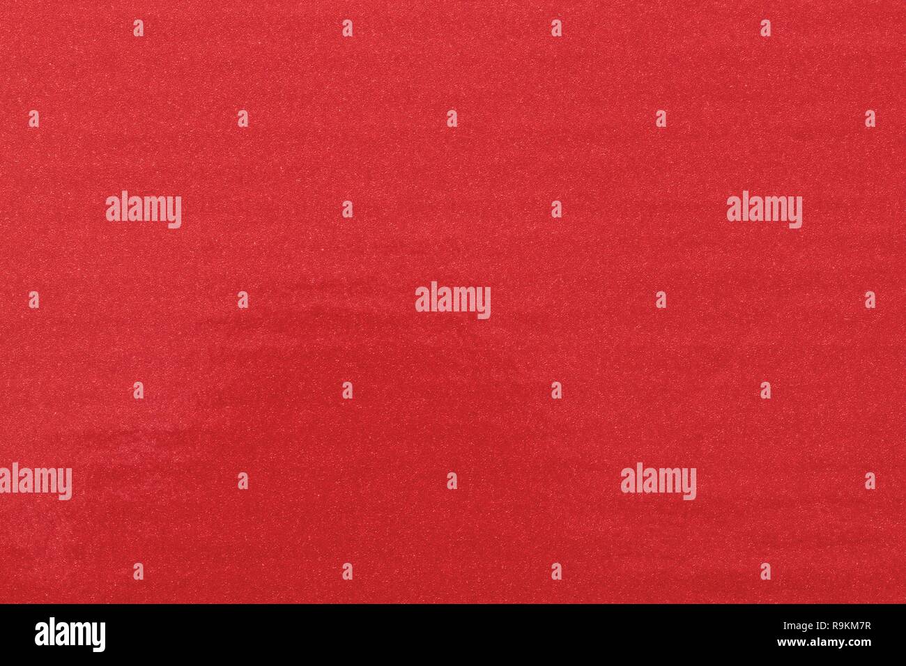 Texture of glitter red paint on plastic sheet, abstract pattern