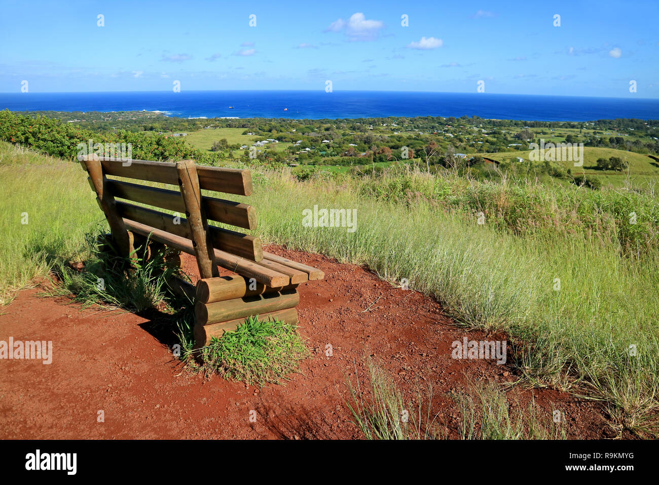 Viewpoint for Hanga Roa and Pacific Ocean with a Wooden Bench on Red Scoria at Puna Pau Volcano, Moai Statues' Topknots Quarry on Easter Island, Chile Stock Photo