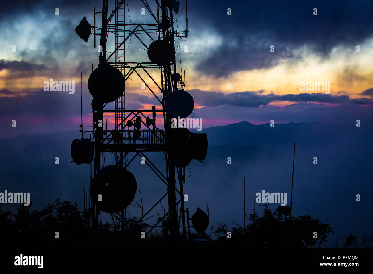 Telecommunication transmitting tower at dawn on top mountain Stock Photo