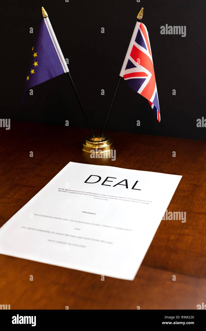 Brexit Concept. Sheet of Paper Headed 'Deal' on a Desk With Table top UK and EU Flags Behind Stock Photo