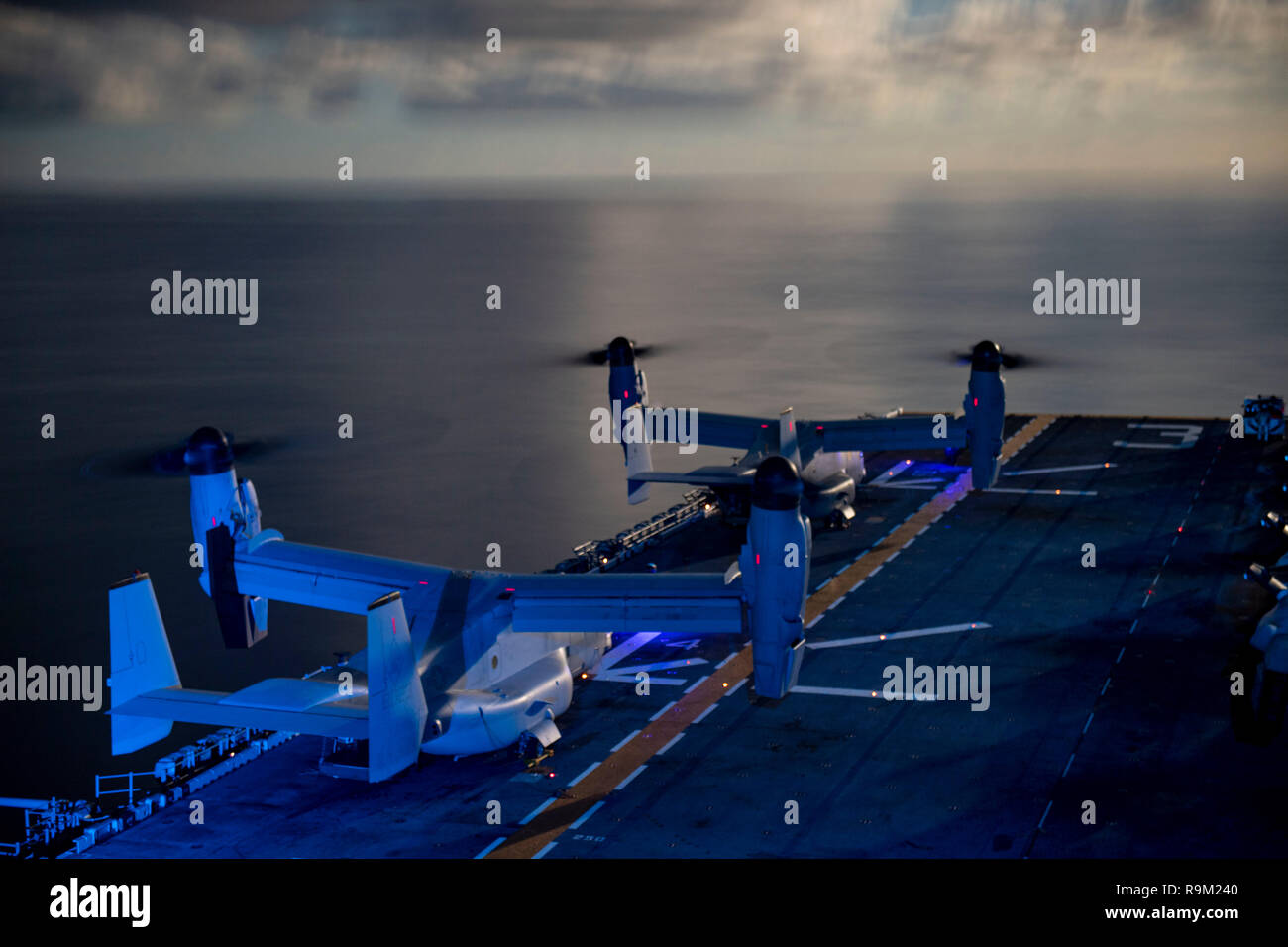 181223-N-UP035-0005 ATLANTIC OCEAN (Dec.23, 2018) MV-22 Ospreys of Marine Medium Tiltrotor Squadron 264 (Reinforced) prepare to launch from the flight deck of the Wasp-class amphibious assault ship USS Kearsarge (LHD 3) during night flight operations. Kearsarge is on a scheduled deployment as part of the Kearsarge Amphibious Ready Group in support of maritime security operations, crisis response and theater security cooperation, while also providing a forward naval presence. (U.S. Navy photo by Mass Communication Specialist 1st Class Mike DiMestico/Released) Stock Photo