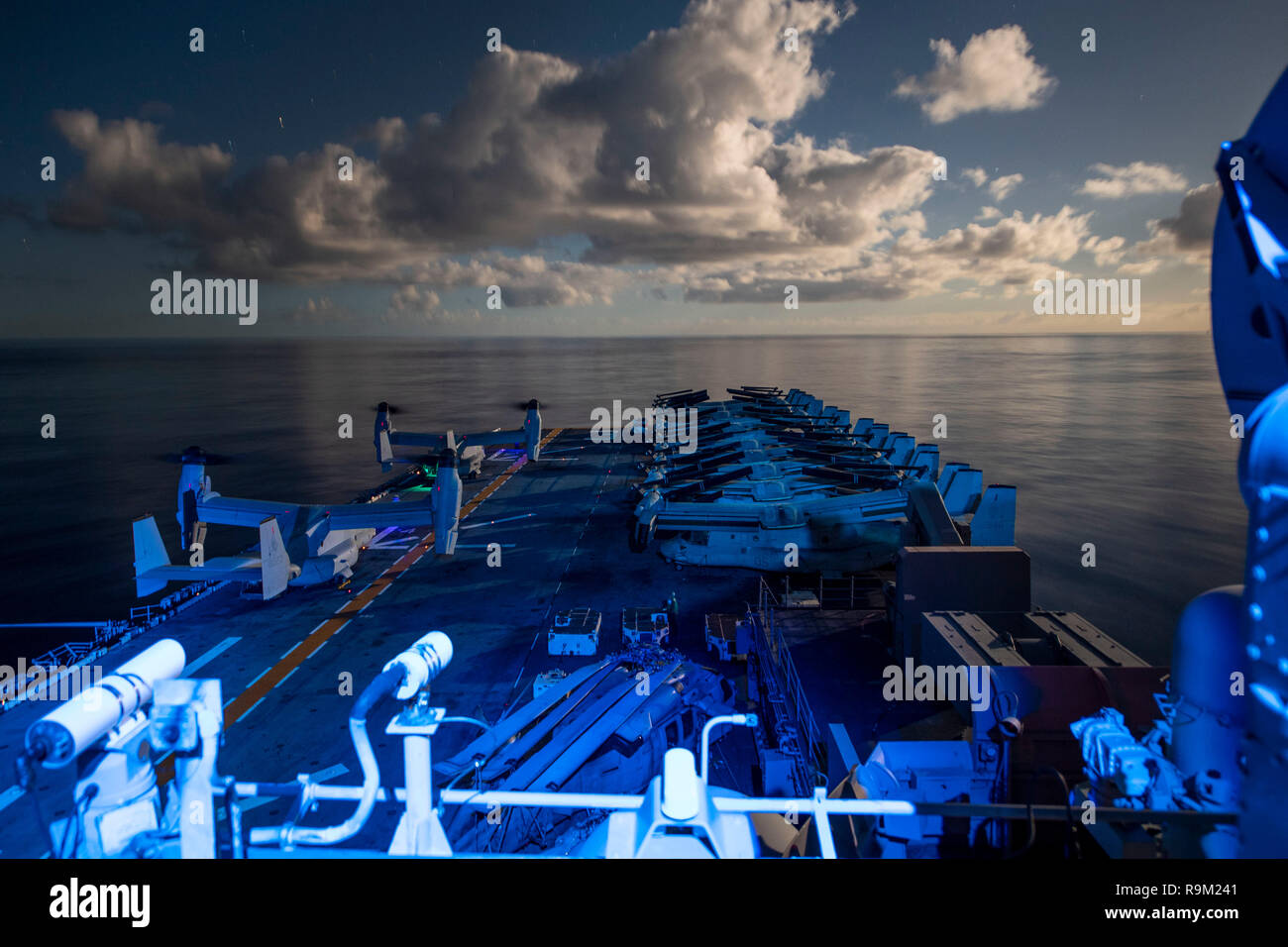 181223-N-UP035-0011 ATLANTIC OCEAN (Dec.23, 2018) MV-22 Ospreys of Marine Medium Tiltrotor Squadron 264 (Reinforced) prepare to launch from the flight deck of the Wasp-class amphibious assault ship USS Kearsarge (LHD 3) during night flight operations. Kearsarge is on a scheduled deployment as part of the Kearsarge Amphibious Ready Group in support of maritime security operations, crisis response and theater security cooperation, while also providing a forward naval presence. (U.S. Navy photo by Mass Communication Specialist 1st Class Mike DiMestico/Released) Stock Photo