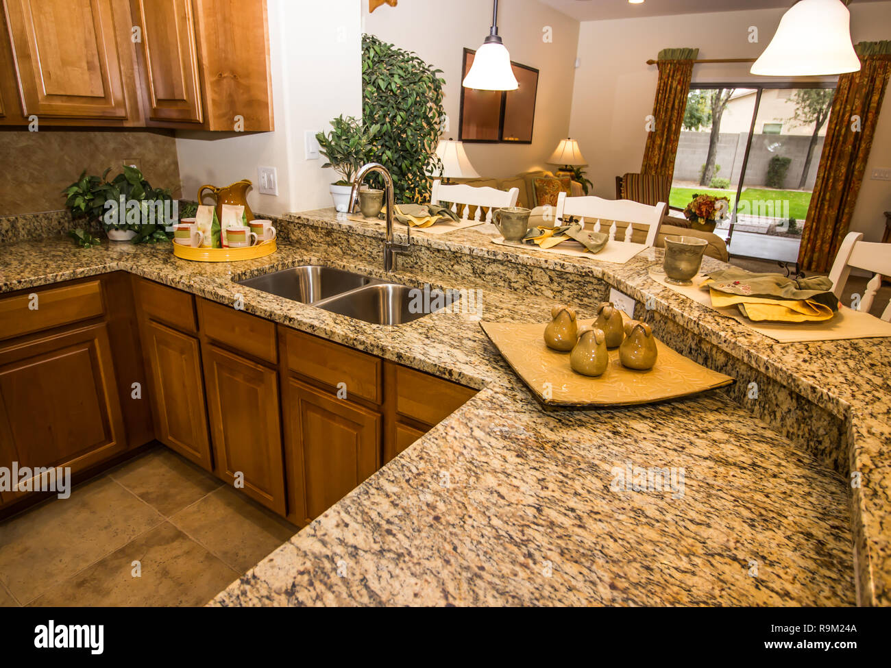 Granite Counter Kitchen With Place Settings And Bar Stools Stock Photo