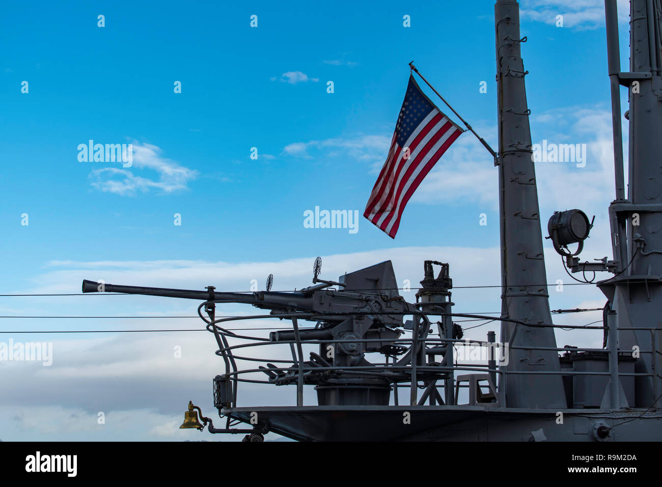 Jan 2017, San Francisco, USA: An American flag flies above a Bofor 40mm anti aircraft gun mounted on the stern of the WW2 USS Pampanito submarine Stock Photo
