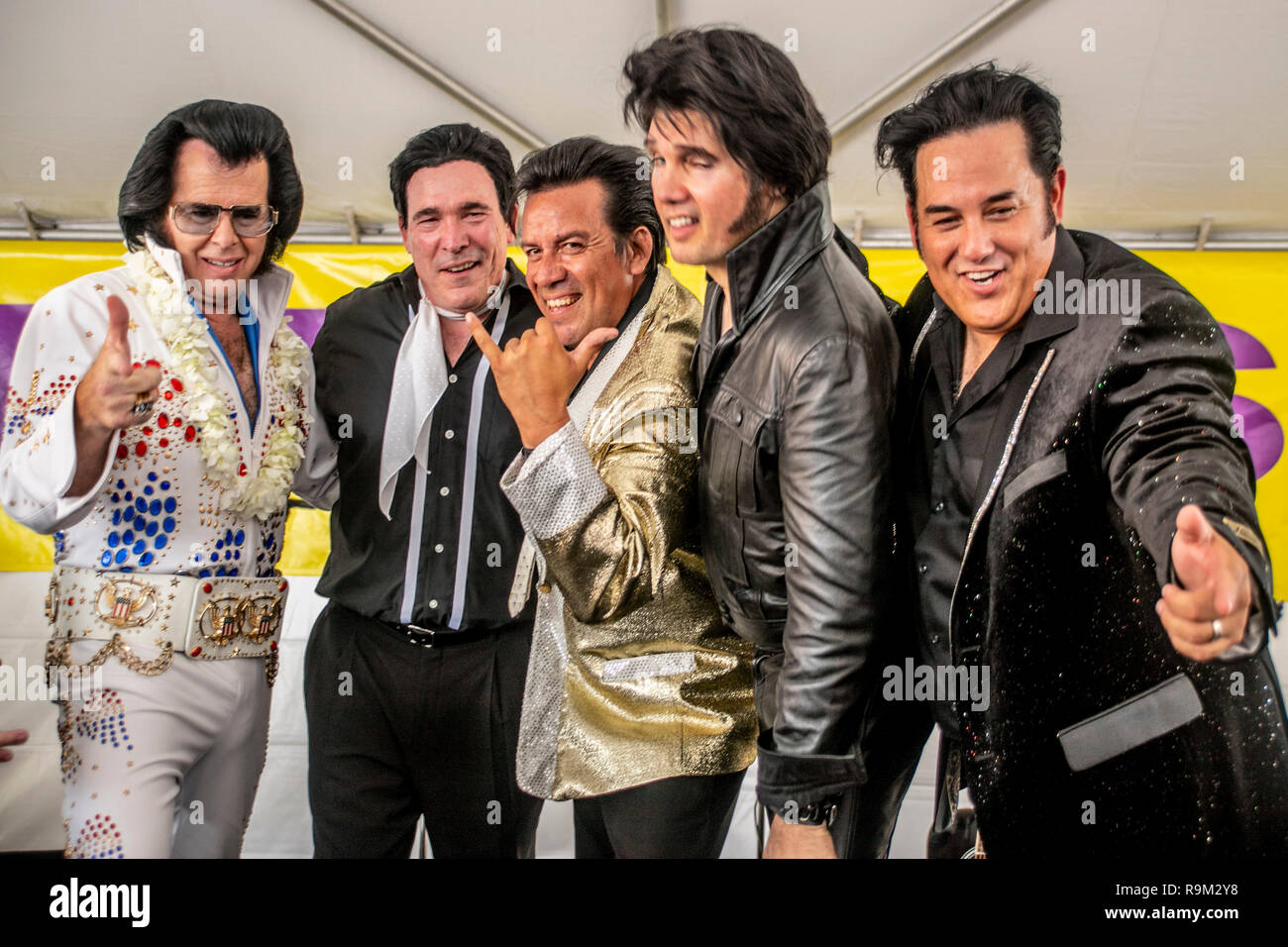 Five costumed Elvis Presley impersonators line up on the stage of a music festival in Fullerton, CA. Stock Photo