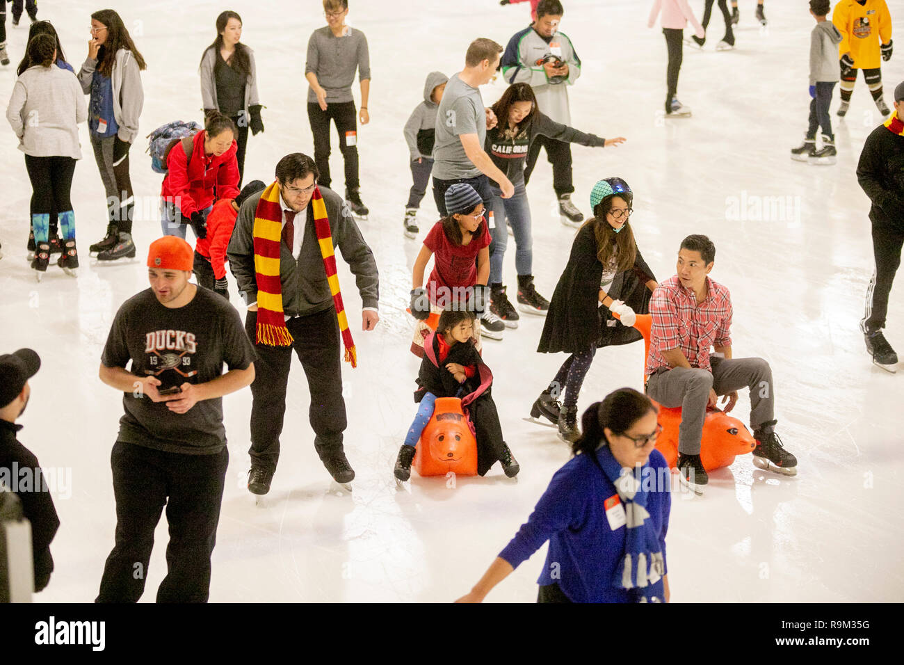 Wearing wizard robes and Gryffindor scarves, Harry Potter book devotees participate in an ice skating event in honor of author J.K. Rowling in Anaheim, CA. Stock Photo