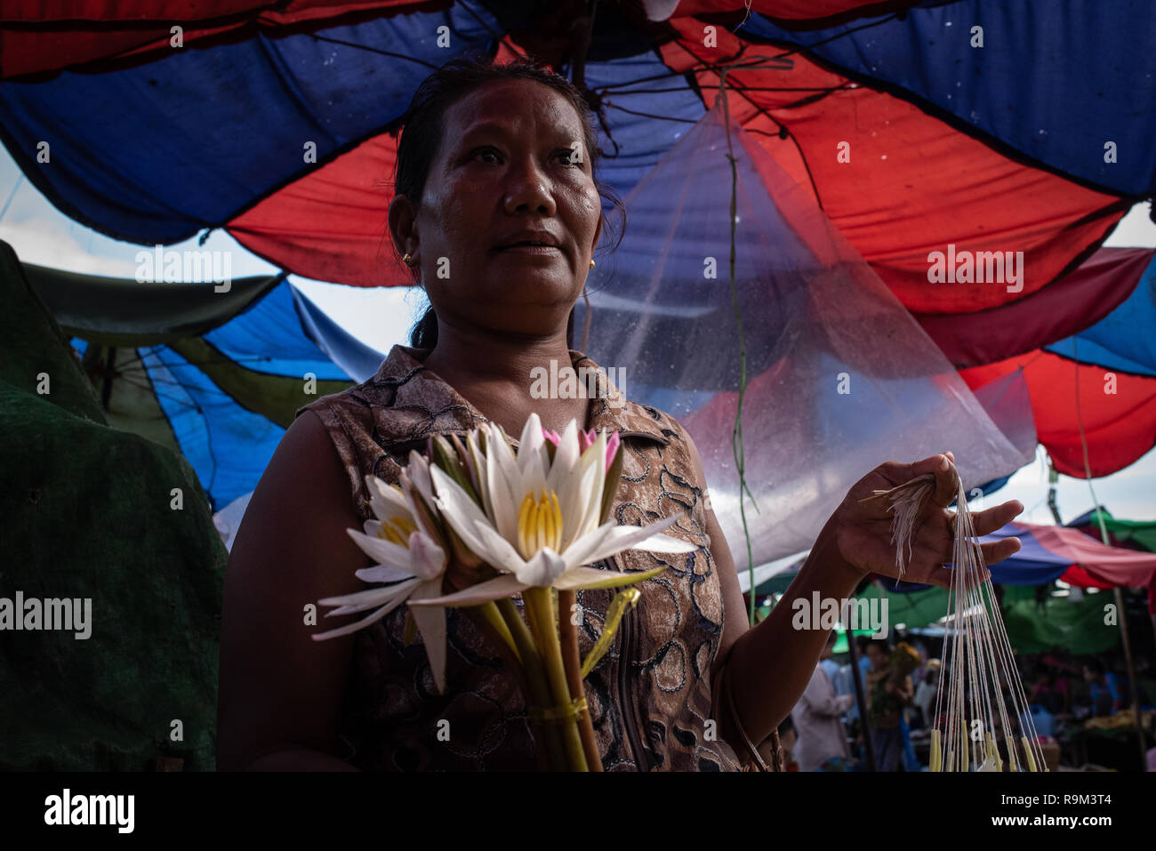 Portrait of a flower vendor in the Sari San Market, Mandalay, Myanmar Stock Photo