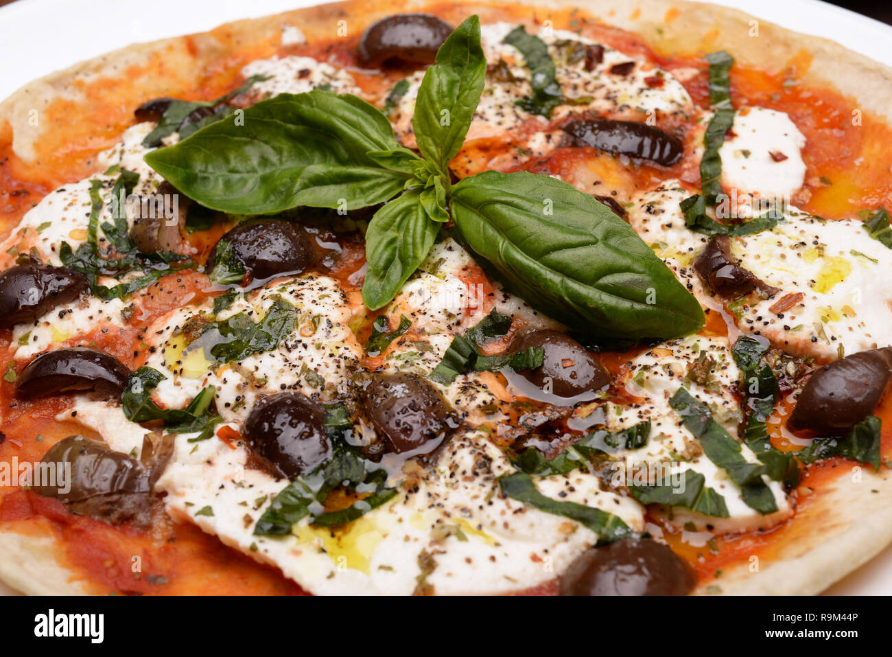 Dish With Cottage Cheese Piadina Olives And Basil In The Table