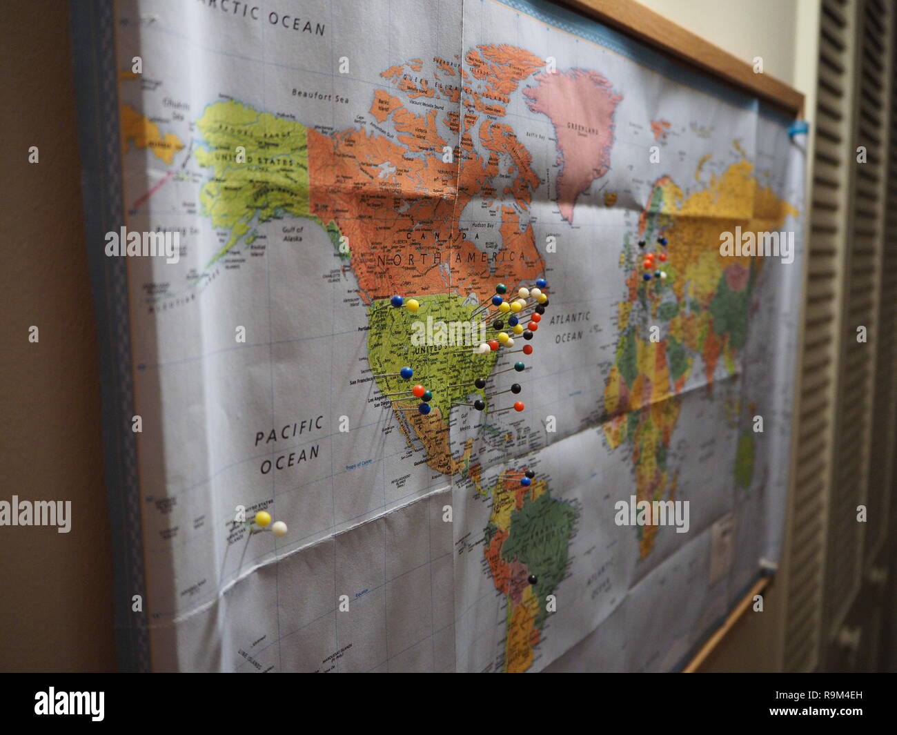 Pins in World Map focused on North America Stock Photo