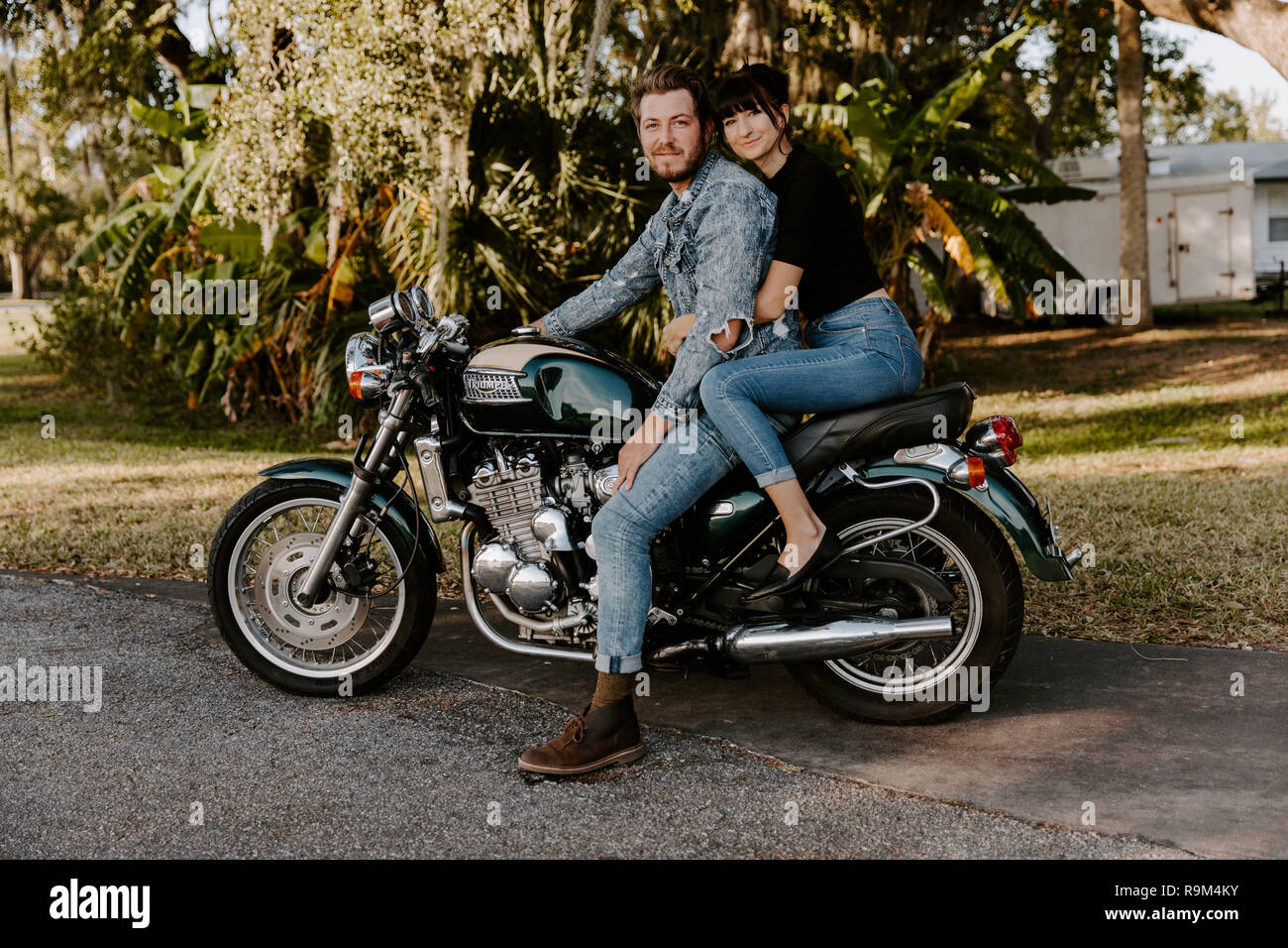 Portrait of Attractive Good Looking Young Modern Trendy Fashionable Guy Girl Couple Riding on Green Motorcycle Cruiser Classic Bike in Love Stock Photo Alamy