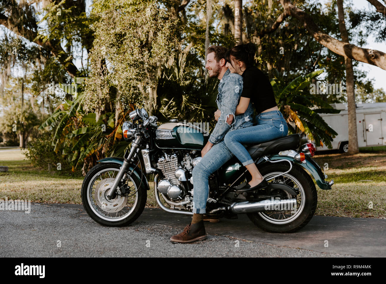 Portrait of Attractive Good Looking Young Modern Trendy Fashionable Guy Girl Couple Riding on Green Motorcycle Cruiser Classic Bike in Love Stock Photo Alamy