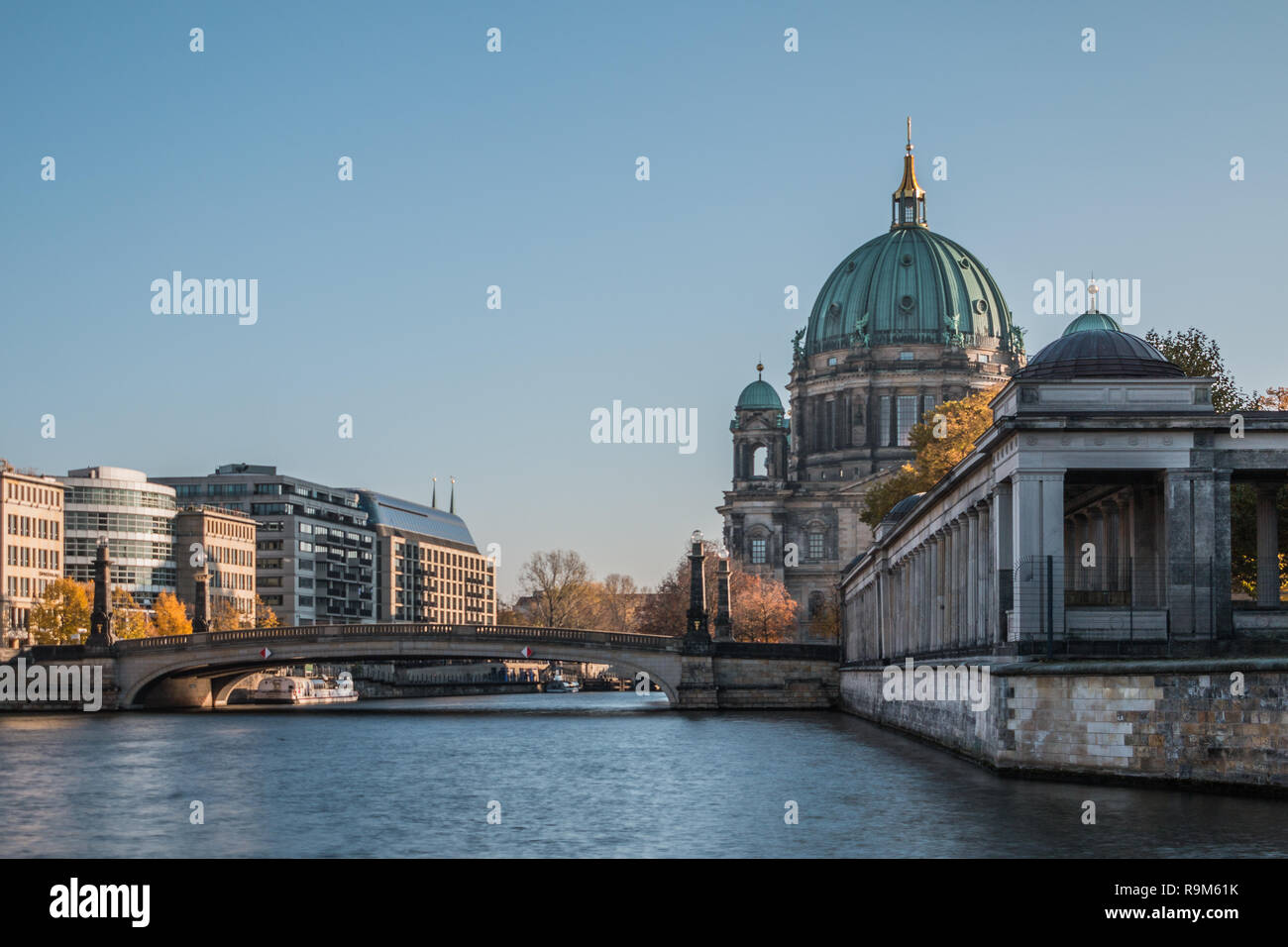 Berlin Cathedral with Friedrichs Bridge over the River Spree. Historic arcade of the National Gallery. Sunny day at blue sky. Stock Photo