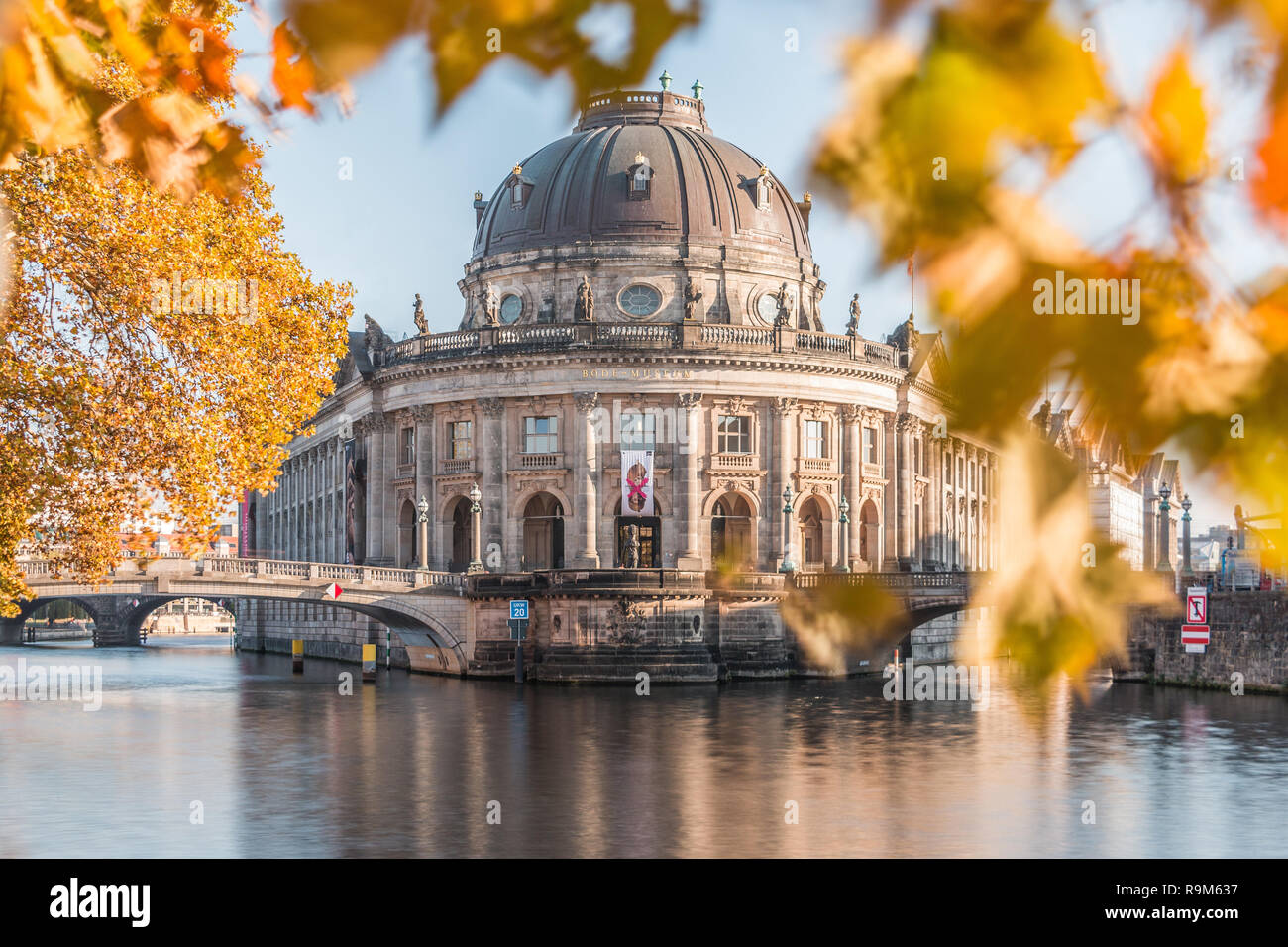 Bode museum in autumn mood. Museum Island in Berlin, capital of Germany, on sunny day with the River Spree and leaves from the tree on a bridge Stock Photo