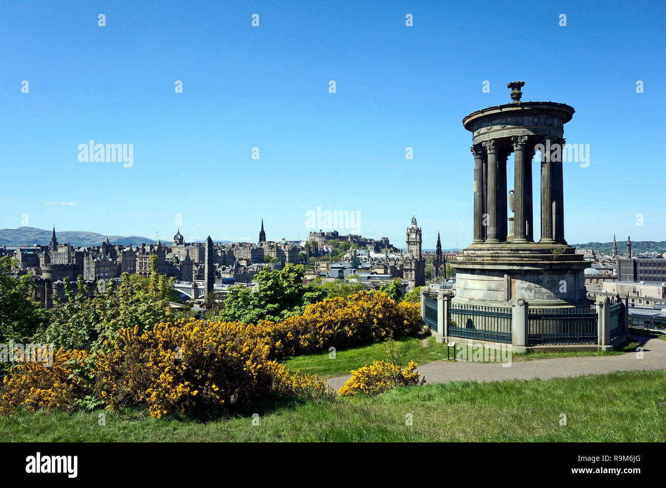 View over Edinburgh towards Edinburgh Castle from Calton Hill at the east end of Princes Street in Edinburgh Scotland UK with Dugald Stewart monument Stock Photo