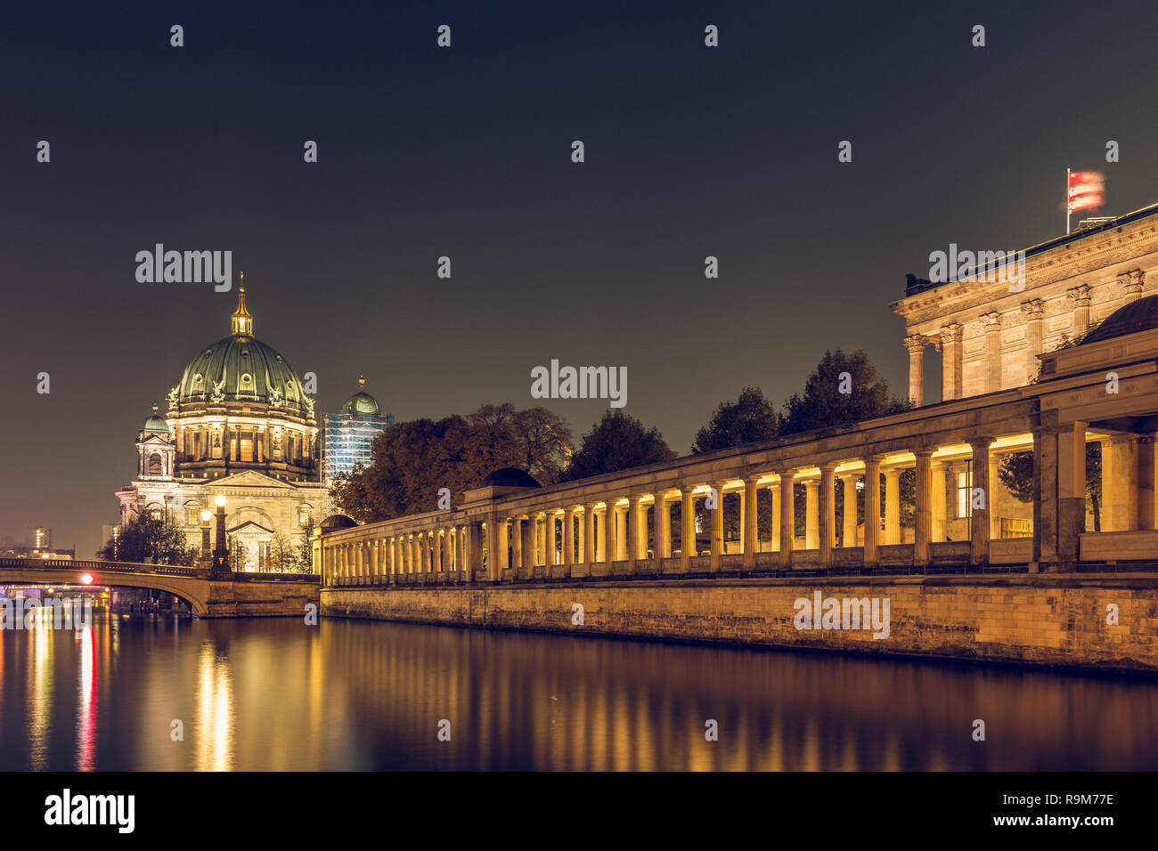 Berlin at night. Berlin Cathedral and the Friedrich's Bridge with lighting and reflections in the river Spree. illuminated arcade of the gallery Stock Photo