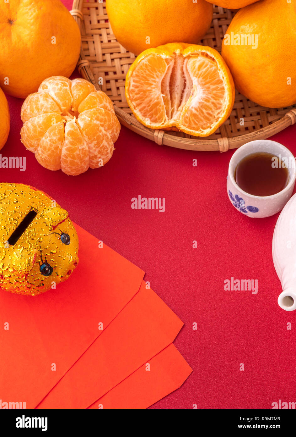 Beautiful and delicious tangerine isolated on red background with chinese  new year decorations, and words on the pig means "May wealth comes to you  Stock Photo - Alamy