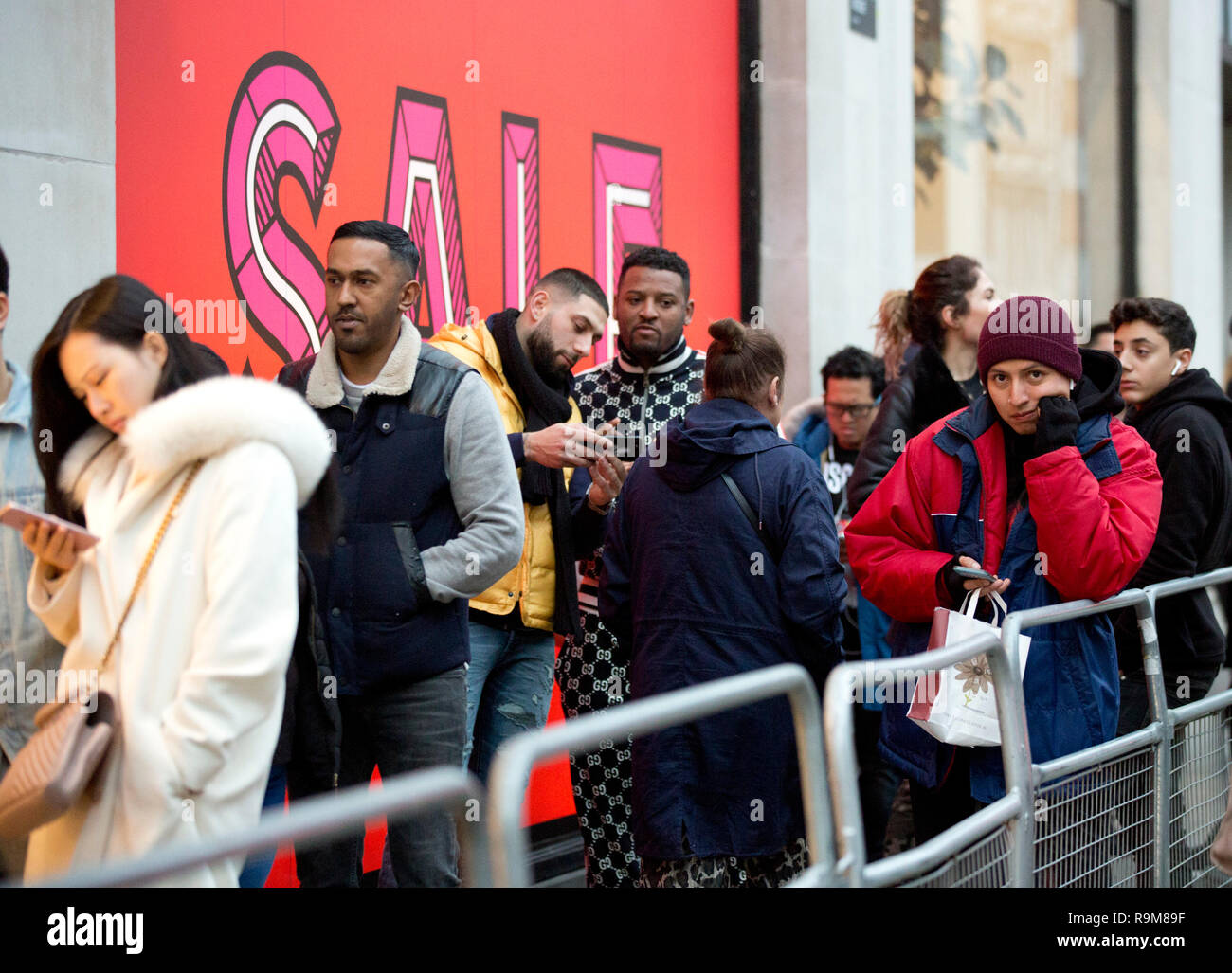 Shoppers queue outside Selfridges on Oxford Street, London before