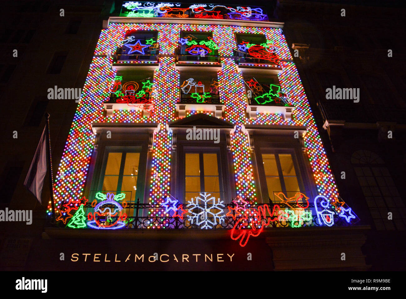 Exterior of the Stella McCartney flagship store on Old Bond Street covered in multi-coloured Christmas lights and decorations Stock Photo