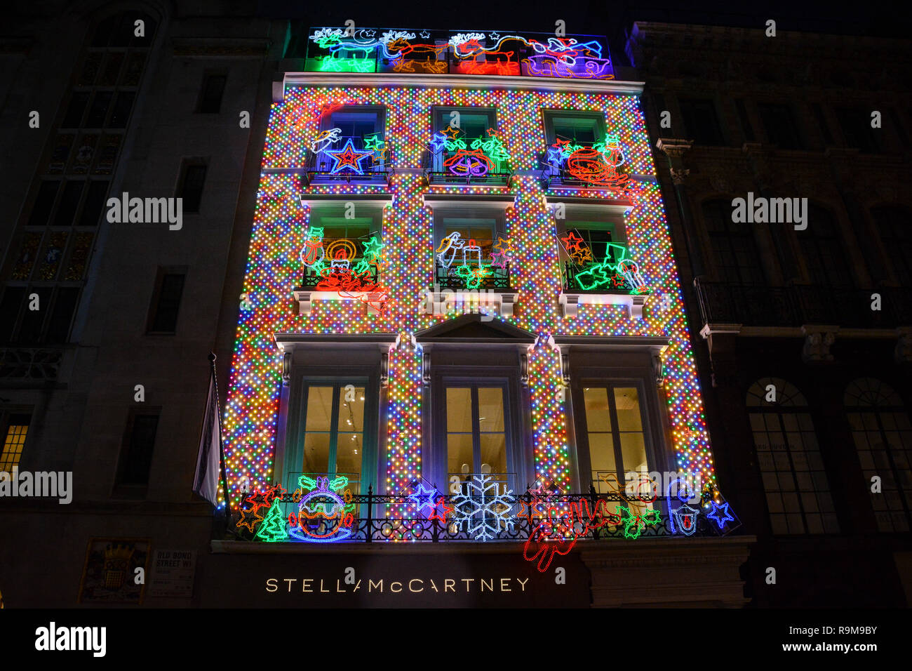 Exterior of the Stella McCartney flagship store on Old Bond Street covered in multi-coloured Christmas lights and decorations Stock Photo