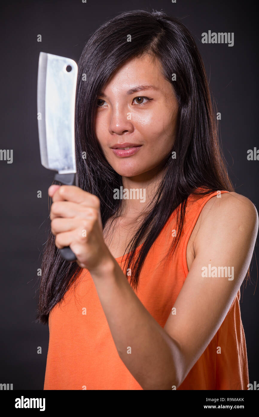 Asian femme fatale with chopping knife Stock Photo Alamy