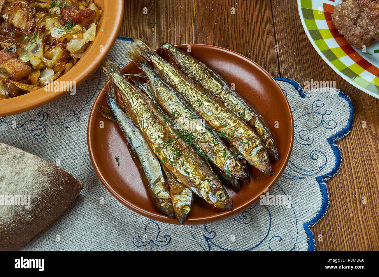 Bockling,  hot-smoked herring similar to the kipper and the bloater, Swedish homemade cuisine, Traditional assorted dishes, Top view. Stock Photo