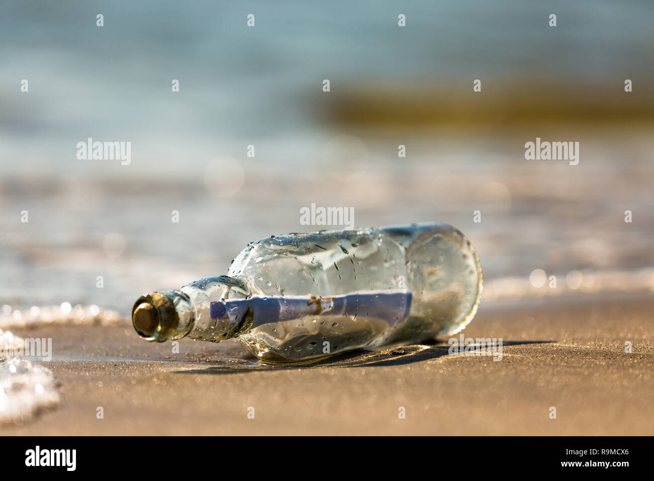 message in a bottle on the shore Stock Photo