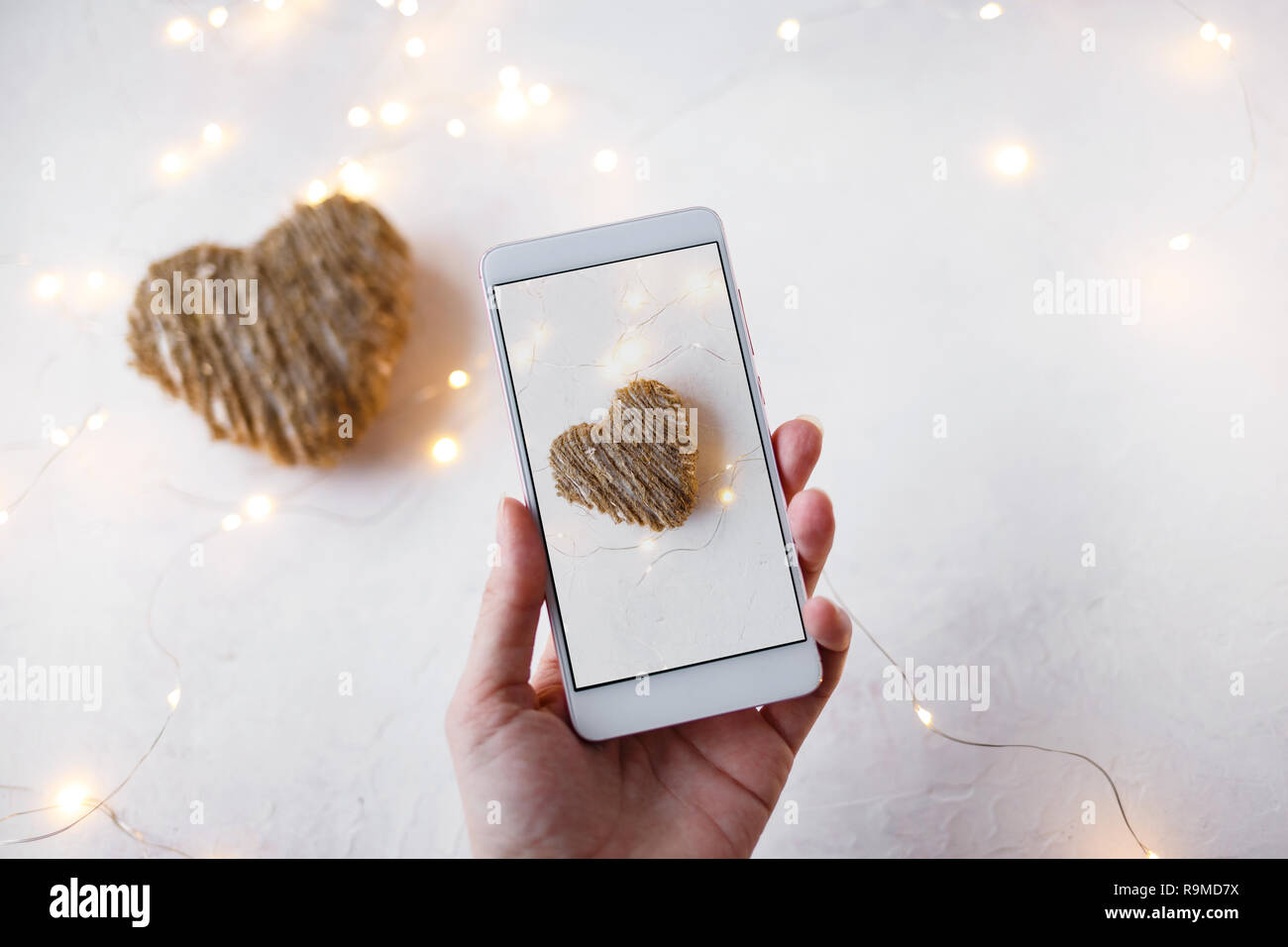 Female Hand With A Phone Takes Pictures Of Decorations For
