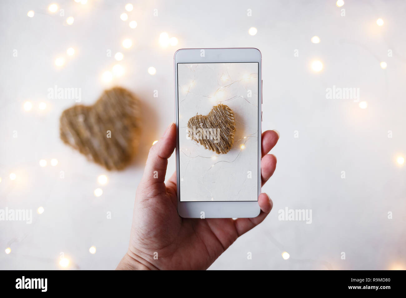 Female Hand With A Phone Takes Pictures Of Decorations For