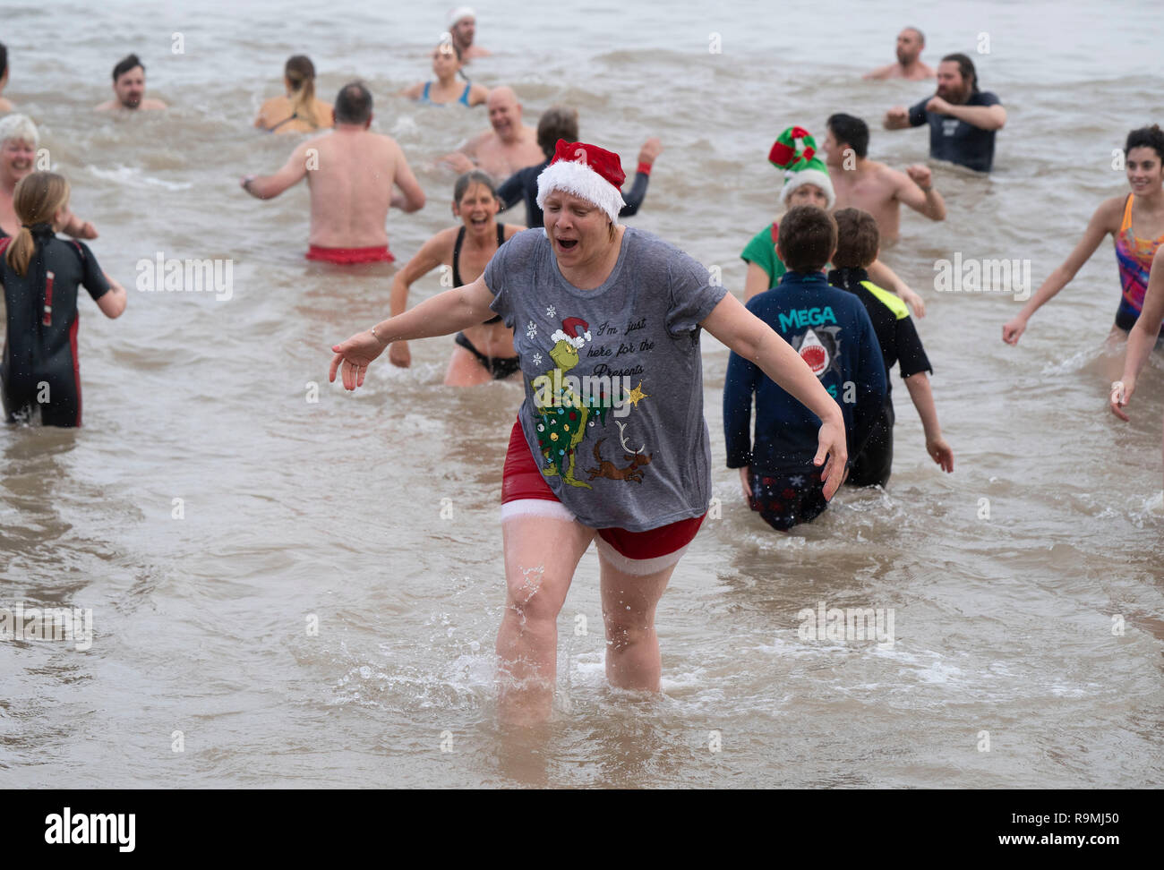 Overstrand, Norfolk, UK, 26th December, 2018. A crowd of hardy swimmers, dive into the sea at Overstrand in Norfolk, England, for the annual Boxing Day Dip, in aid of local charities, on December 26, 2018. Photo by David Levenson/Alamy Live News Stock Photo