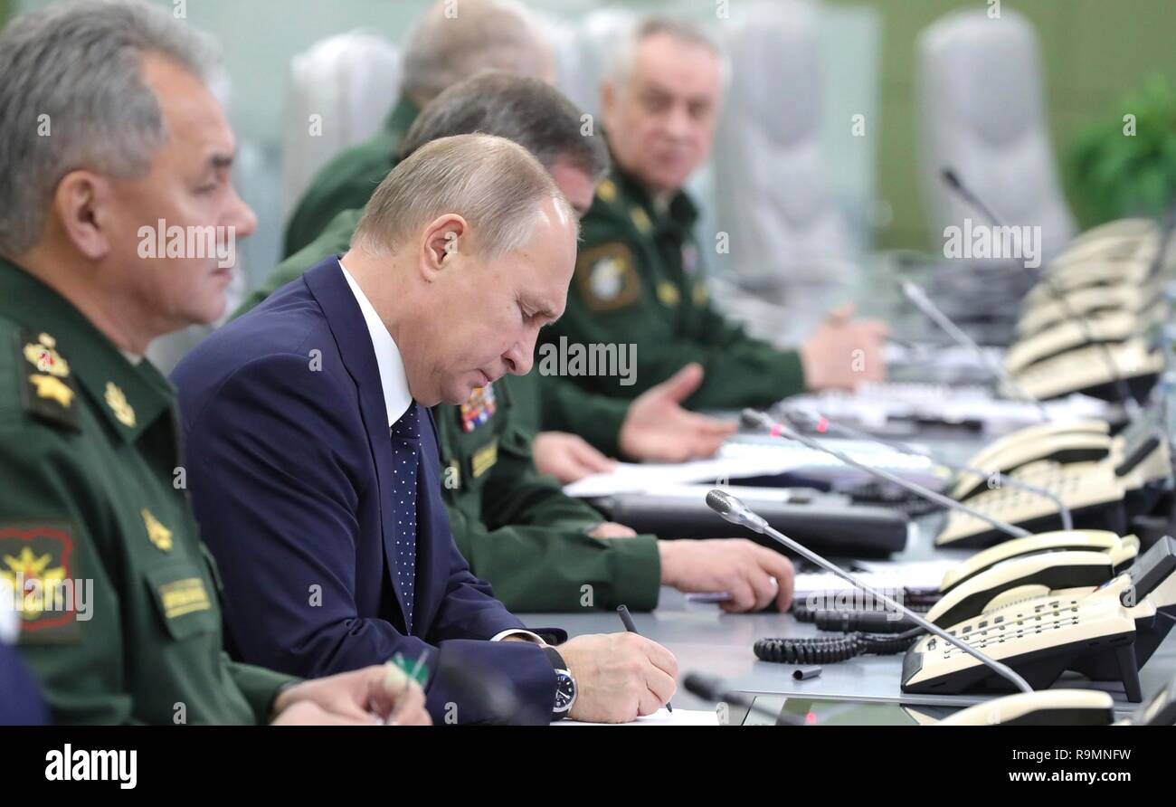 Moscow, Russia. 26th December, 2018. Russian President Vladimir Putin, center, alongside Defense Minister Sergei Shoigu, left, and Army Chief Gen. Valery Gerasimov, right, during a test firing of the Avangard hypersonic glide vehicle from the National Centre for State Defence Control room December 26, 2018 in Moscow, Russia. The Avangard was launched from the Dombarovskiy missile base in the southern Ural Mountains. Credit: Planetpix/Alamy Live News Stock Photo