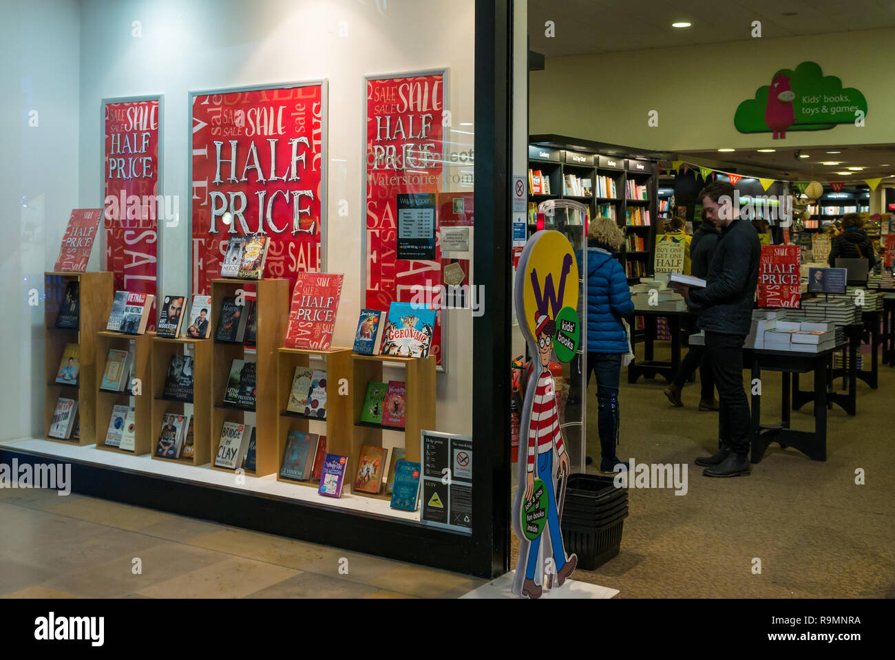 Ocean Terminal shopping centre, Leith, Edinburgh, Scotland, United Kingdom, 26th December 2018. Waterstones book store front advertising a half price Boxing Day sale with shoppers browsing inside the bookshop Stock Photo
