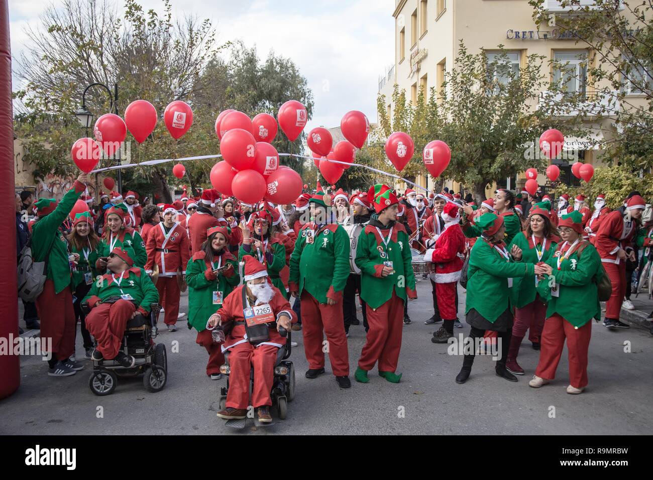 Chania, Greece. 26th Dec, 2018. Participants are seen drinking beer during  the annual Santa Run event.Hundreds of people Wearing Santa Claus costumes  participate at the annual Santa Run in Chania. Credit: Nikolas