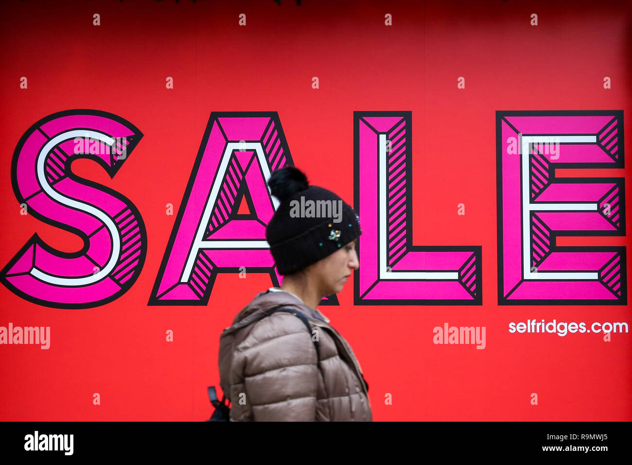 A Shopper Is Seen Walking Past A Large Sale Sign On Selfridges Window As Its Sale