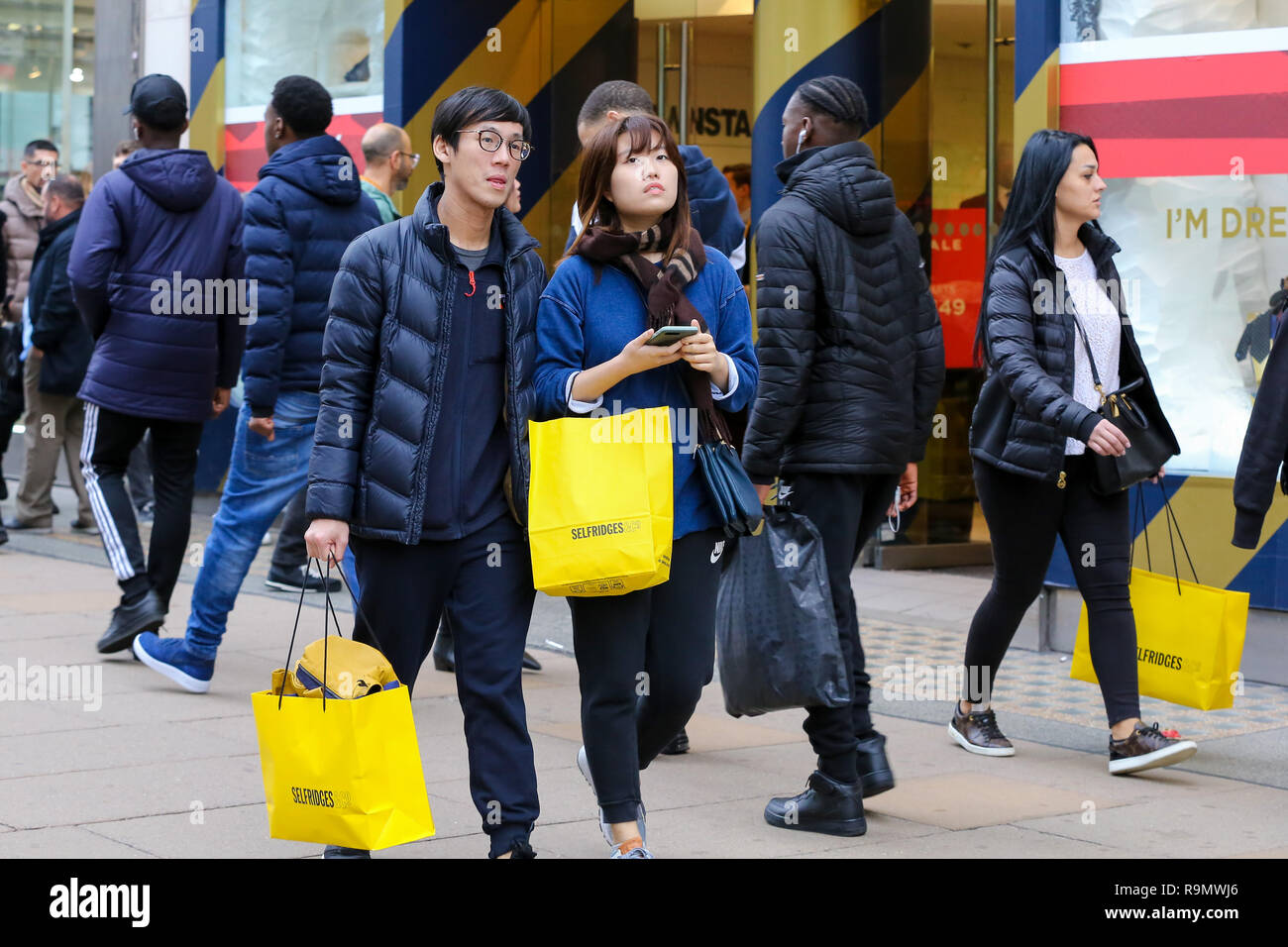 Shoppers are seen with Selfridges shopping bags on London s Oxford