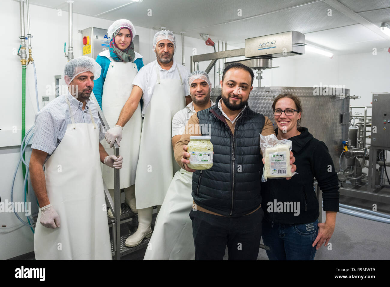 Illingen, Germany. 28th Nov, 2018. Abdul Saymoa shows together with a team and business partner anna Riehm (r) his Chalali and Baladia cheese. After his escape from Syria, Saymoa began to produce and sell cheese typical of his homeland. (to dpa 'How a Syrian in Saarland came across cheese' from 27.12.2018) Credit: Oliver Dietze/dpa/Alamy Live News Stock Photo