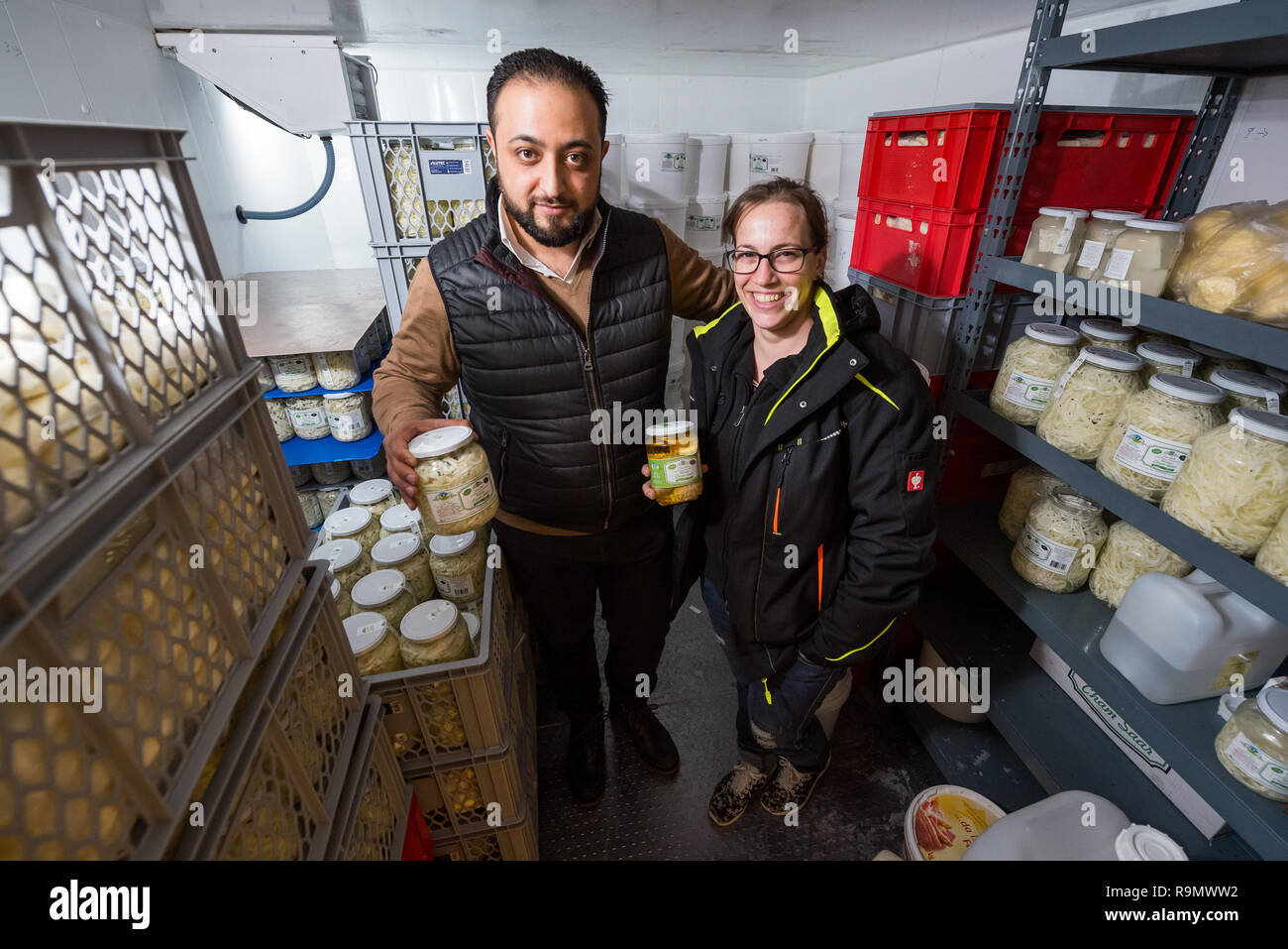 Illingen, Germany. 28th Nov, 2018. Abdul Saymoa and Anna Riehm are standing in the cold store of the Cham Saar cheese dairy. After his escape from Syria, Saymoa, with the support of Riehm, began to produce and sell cheese typical of his homeland. (to dpa 'How a Syrian in Saarland came across cheese' from 27.12.2018) Credit: Oliver Dietze/dpa/Alamy Live News Stock Photo