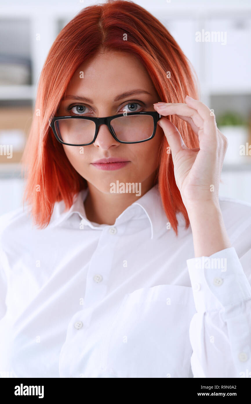 Red haired business woman with glasses Stock Photo