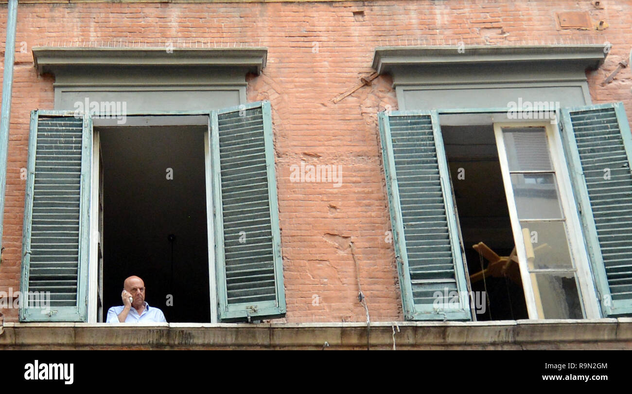 An Italian man standing at the window. Stock Photo
