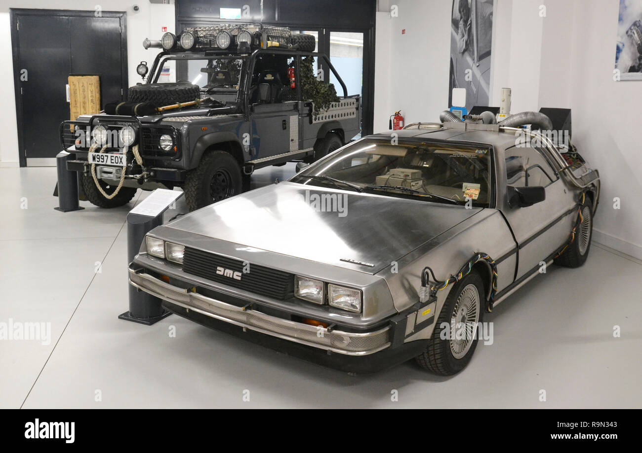 1981 DeLorean DMC-12 from Back to the Future Part 2, and Land Rover Defender 110 HCPU from Tomb Raider. British Motor Museum, Gaydon, Warwickshire, UK Stock Photo