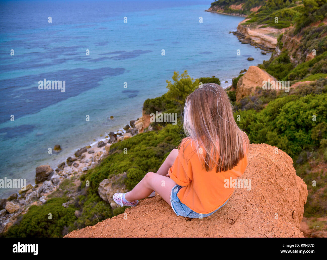 Girl Sitting On Edge Cliff High Resolution Stock Photography and Images ...
