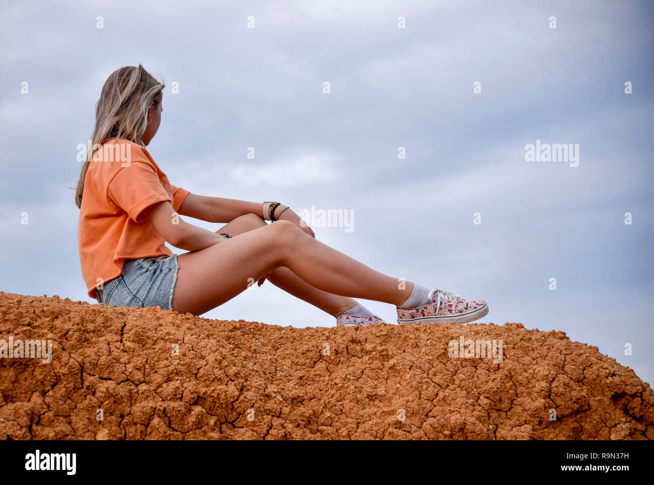 Girl Sitting On Edge Cliff High Resolution Stock Photography and Images