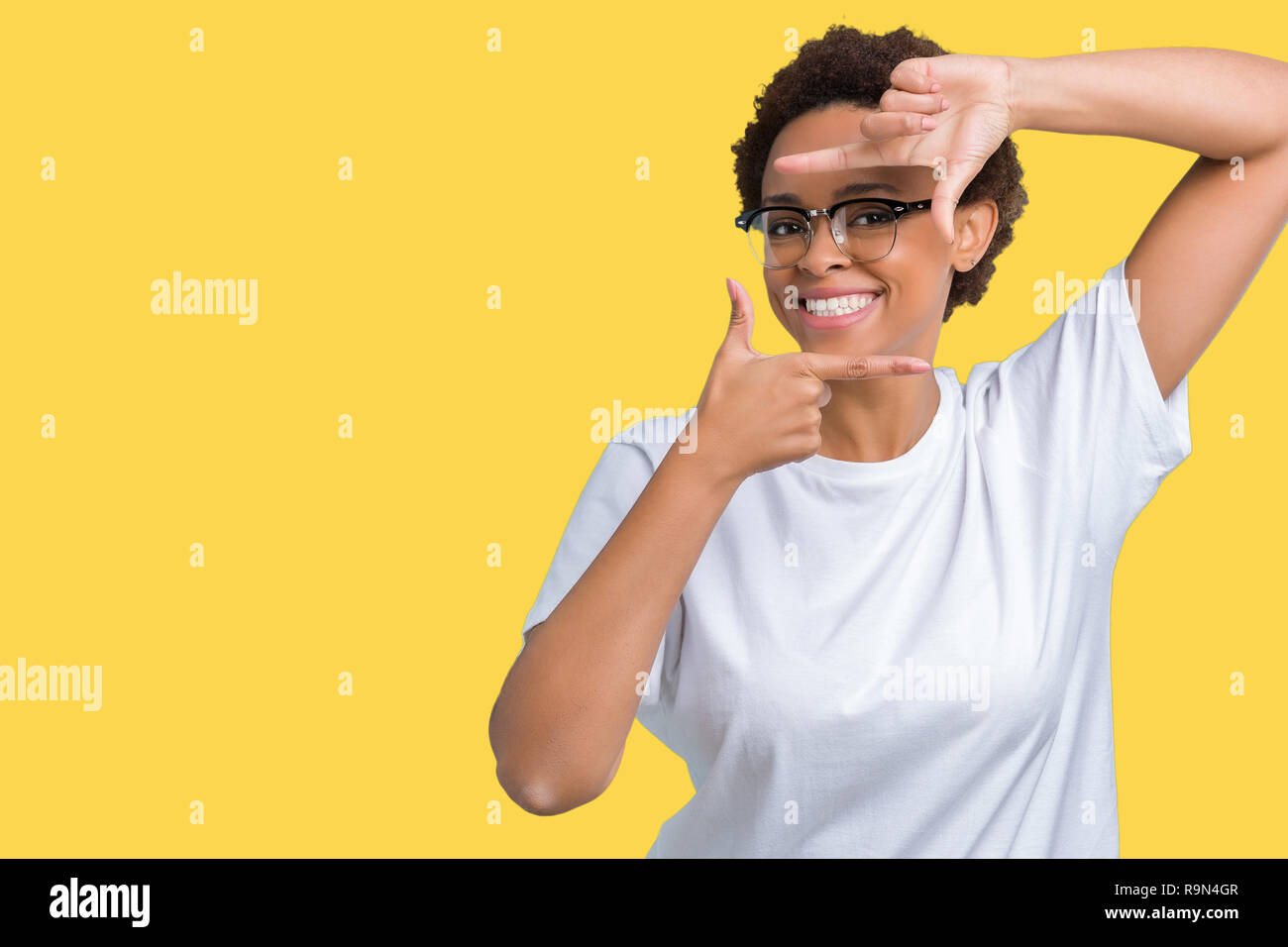 Beautiful young african american woman wearing glasses over isolated ...
