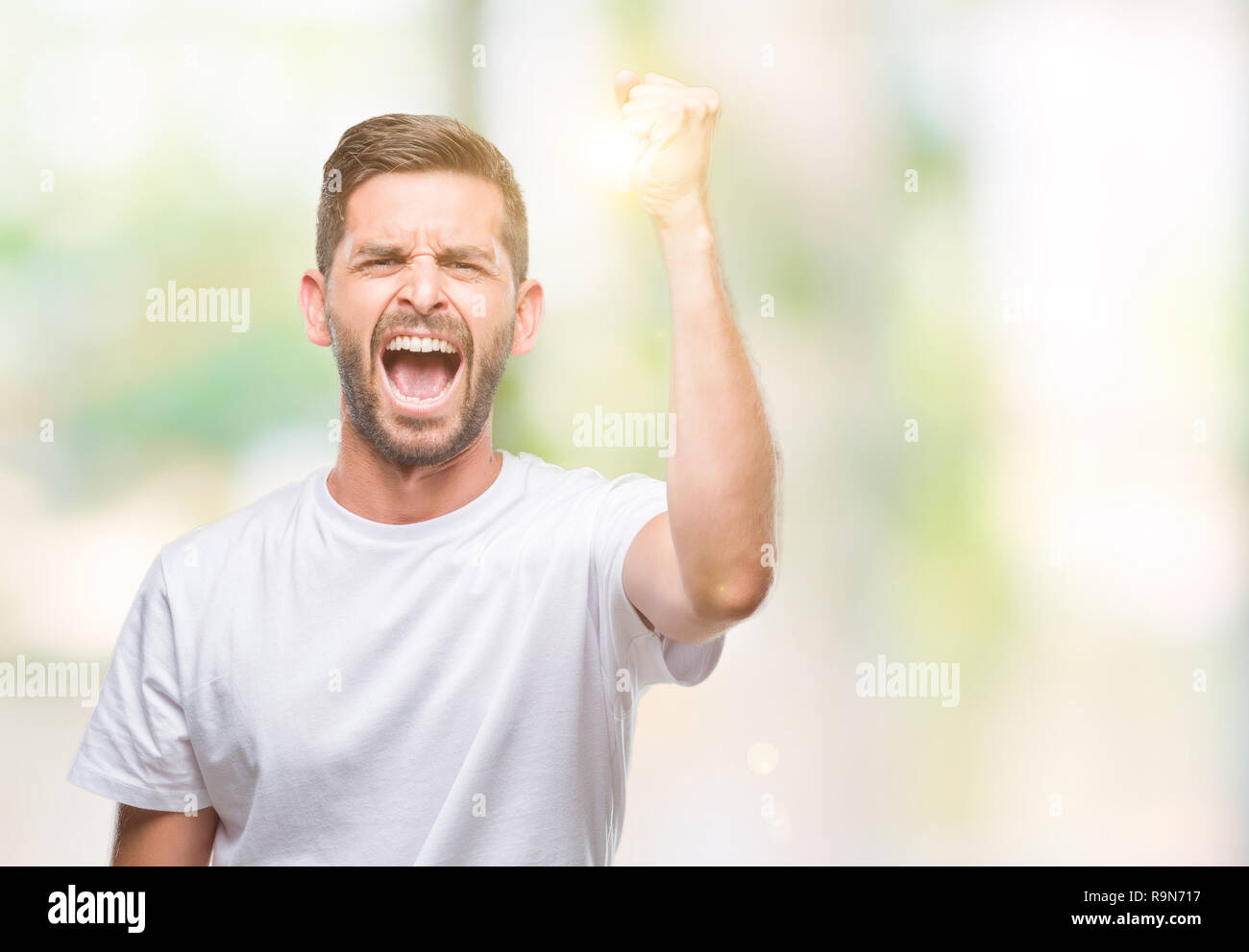Guy Raging Stock Young handsome man over isolated background angry and mad raising fist ...