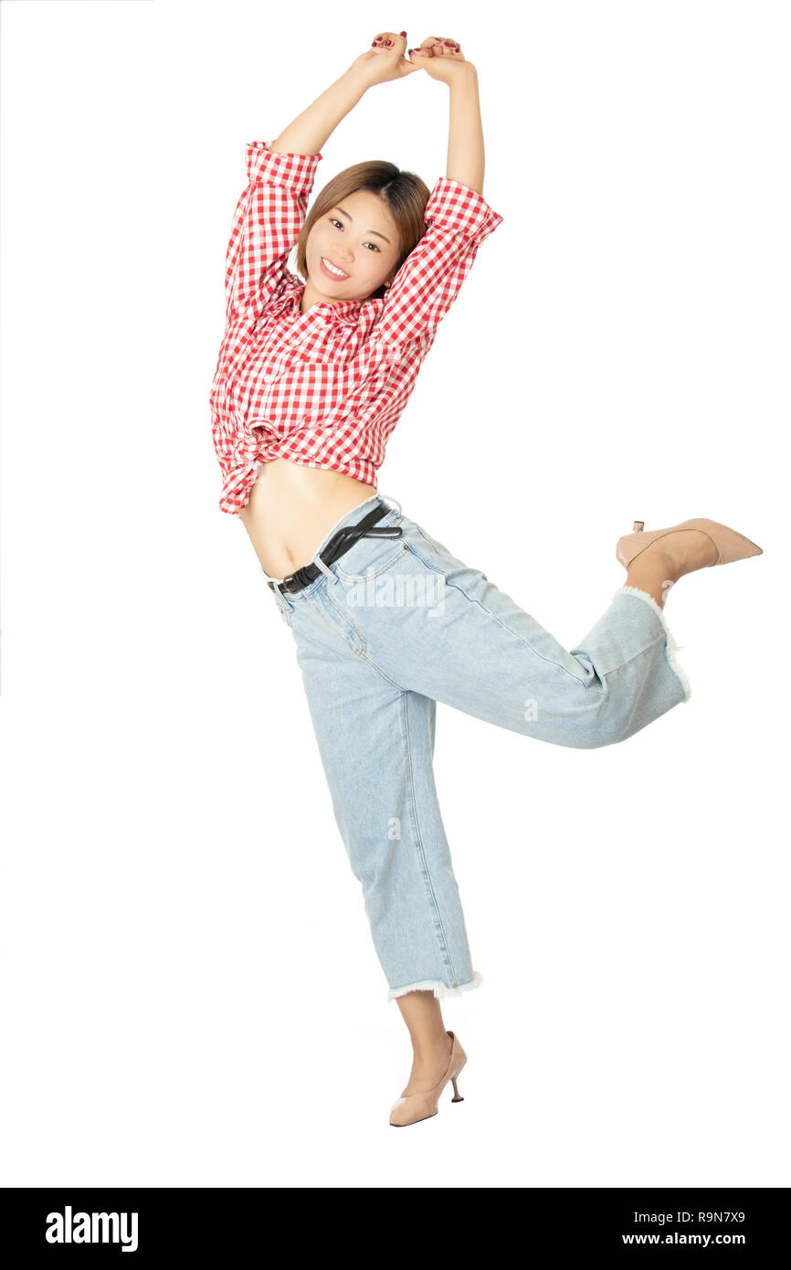 Beautiful Chinese American woman dressed in casual clothing jumping isolated on white background Stock Photo