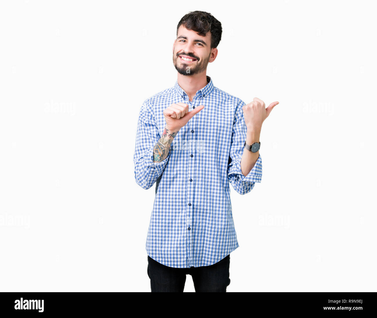 Young handsome business man over isolated background Pointing to the back behind with hand and thumbs up, smiling confident Stock Photo