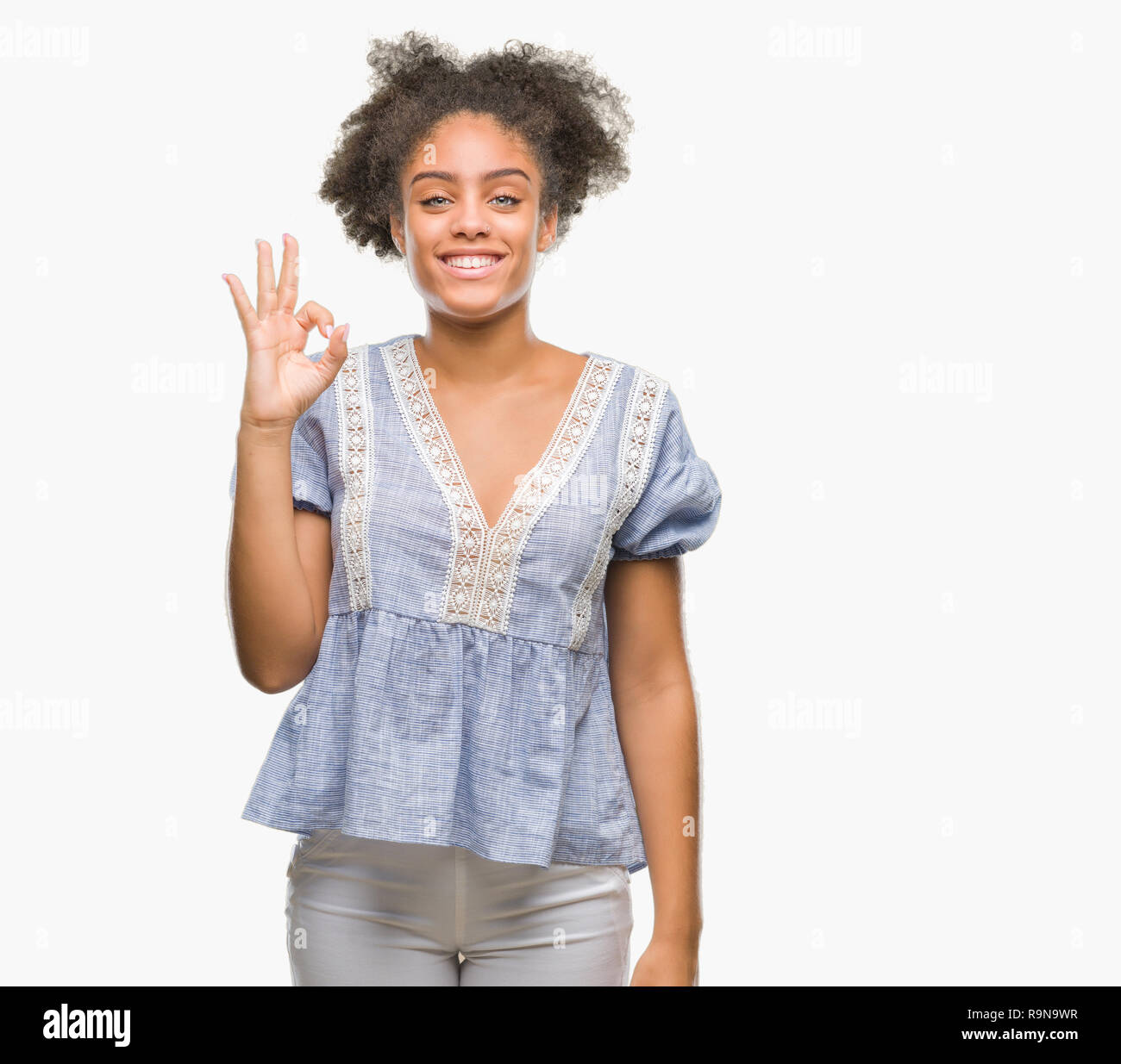 Young afro american woman over isolated background smiling positive ...