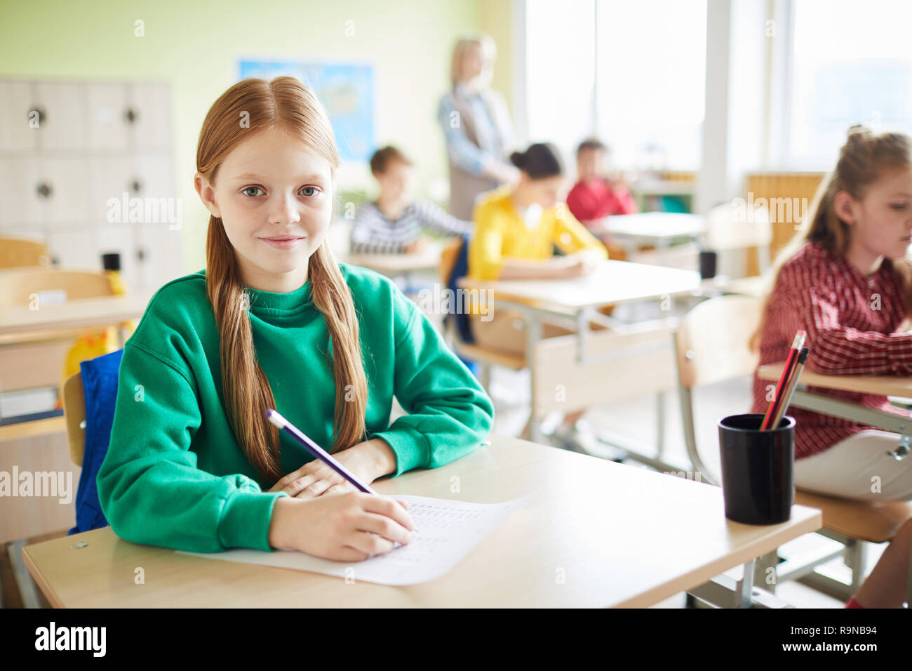 Positive girl writing test Stock Photo Alamy