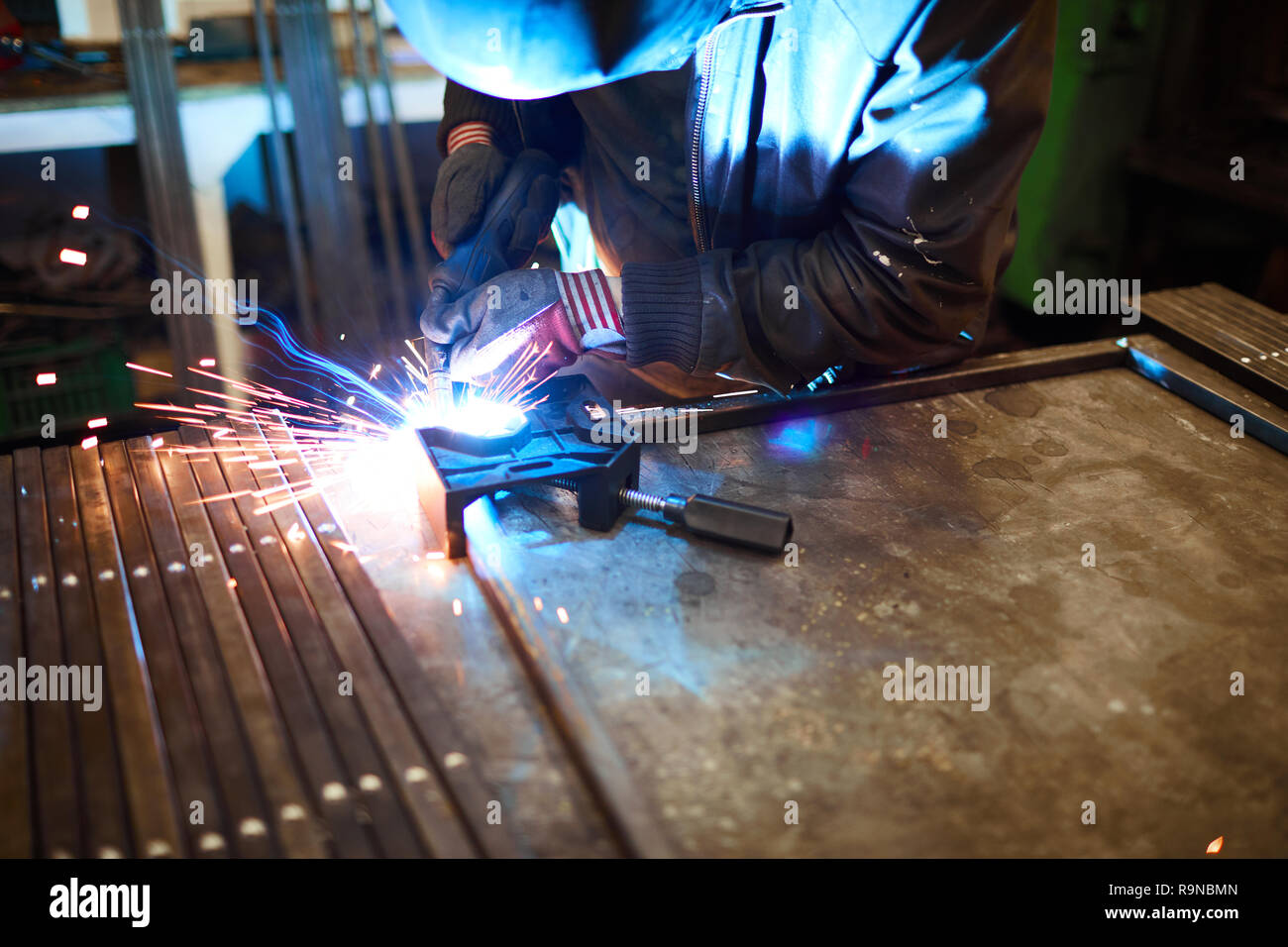 Arc welding in dark workshop Stock Photo