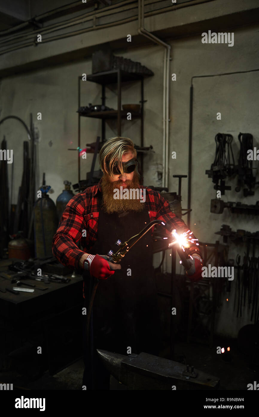 Cutting steel with torch in workshop Stock Photo