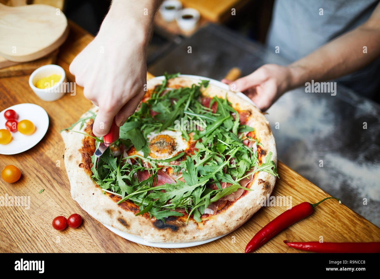 Cutting pizza before serving Stock Photo Alamy